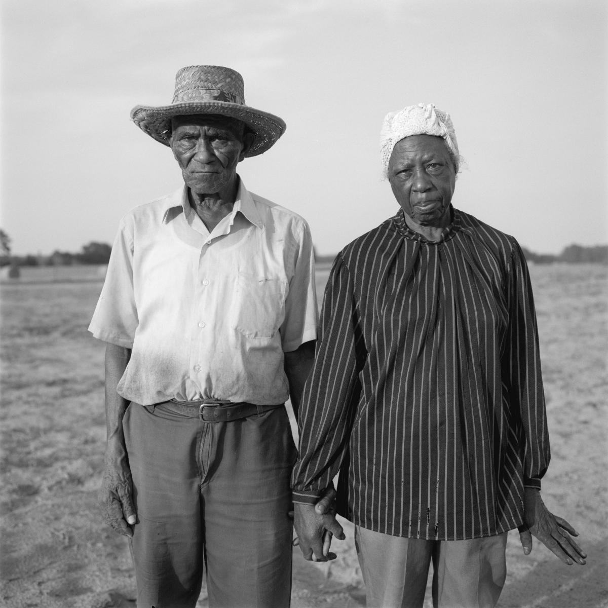 <p><center>Marion County, Florida:</center></p>
A second generation farmer, John Burton grows and handpicks Valencia peanuts with the help of his wife, Evelena. Because the peanuts grow on the roots, the farmers must pull the plant from the soil before picking the shells. The process strains back muscles and fingers, as is evident when Evelena stretches he hand after working in the field for several hours. : Images : AMERICAN BLACK FARMERS PROJECT - John Ficara