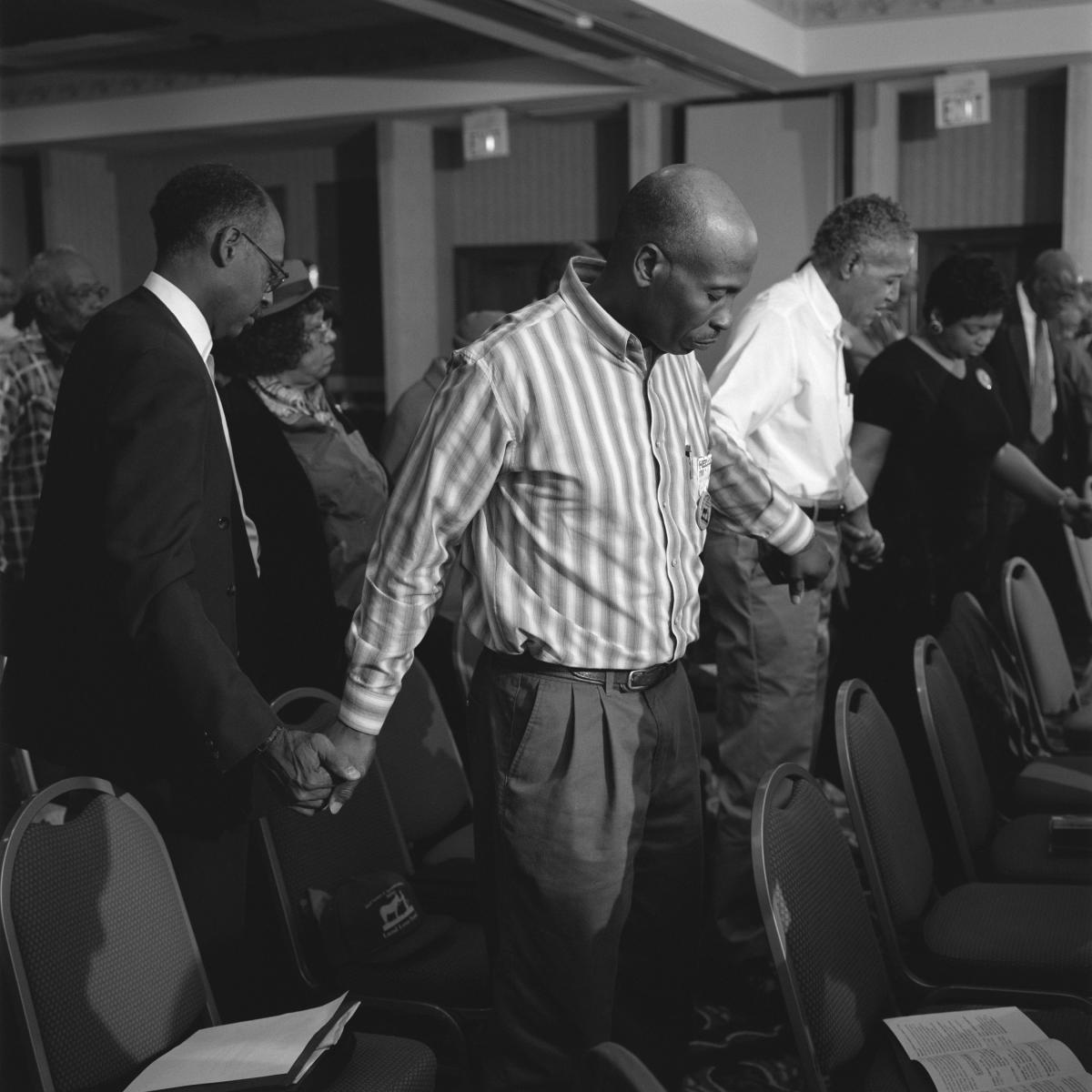 <p><center>Durham, North Carolina:</center></p>
Opening prayers at the Land Loss Summit. : Images : AMERICAN BLACK FARMERS PROJECT - John Ficara